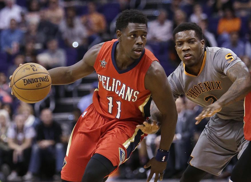 FILE - In this Feb. 13, 2017, file photo, New Orleans Pelicans guard Jrue Holiday (11) drives on Phoenix Suns guard Eric Bledsoe during an NBA basketball game in Phoenix. Holiday will become an unrestricted free agent in the offseason. (AP Photo/Rick Scuteri, File)
