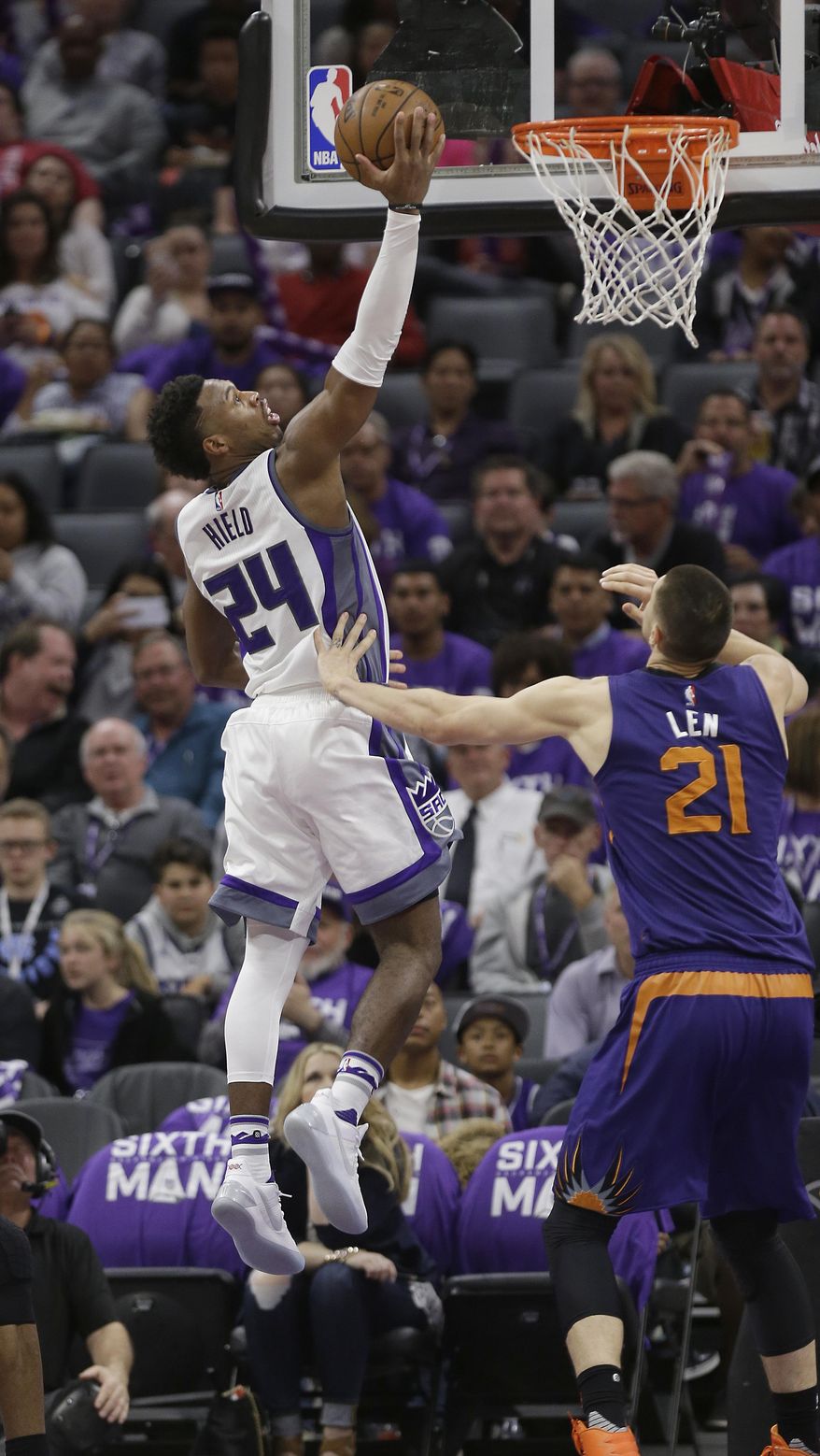 Sacramento Kings guard Buddy Hield, left, drives to the basket against Phoenix Suns center Alex Len during the second half of an NBA basketball game Tuesday, April 11, 2017, in Sacramento, Calif. The Kings won 129-104. (AP Photo/Rich Pedroncelli)