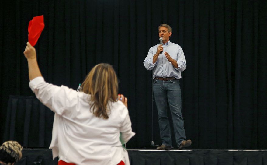 Arizona Republican Sen. Jeff Flake tries to answer a question during a town hall Thursday, April 13, 2017, in Mesa, Ariz. Flake is holding his first public event with constituents since January after coming under withering criticism for his voting record and avoiding such gatherings in recent months. (AP Photo/Ross D. Franklin)