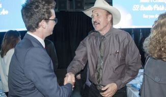 FILE - In this March 18, 2017 file photo, Congressional candidate Rob Quist meets with supporters during the annual Mansfield Metcalf Celebration dinner hosted by the state&#x27;s Democratic Party in Helena, Montana. He is trying to fire up the party faithful in his race against Republican Greg Gianforte in a May 25 special election to fill Montana&#x27;s sole congressional seat. (AP Photo/Bobby Caina Calvan, File)