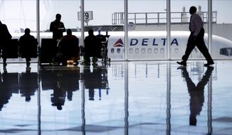 A Delta Air Lines jet sits at a gate at Hartsfield-Jackson Atlanta International Airport, in Atlanta. (AP Photo/David Goldman, File)