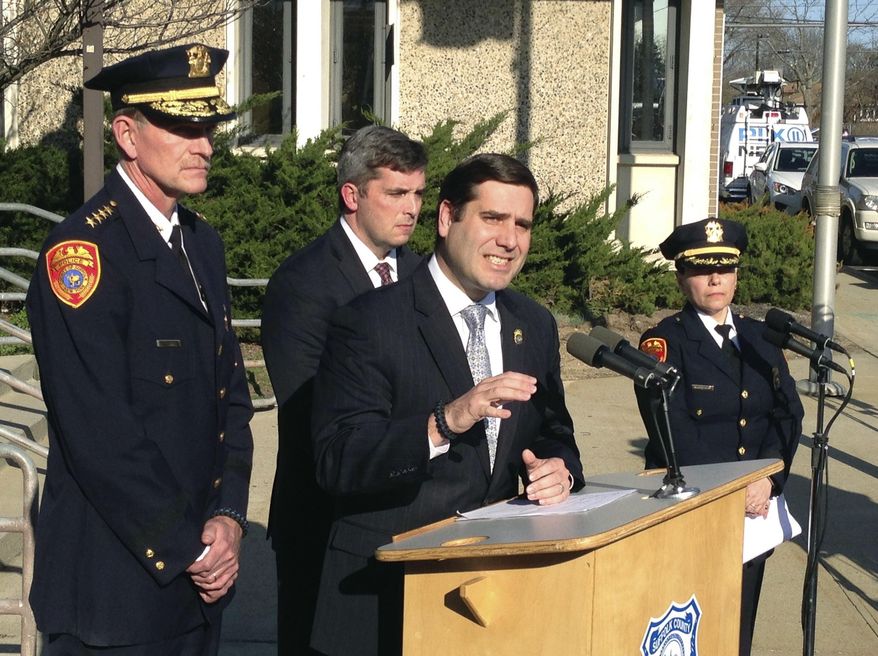Suffolk County Police Commissioner Timothy Sini, center, addresses the media outside Police Headquarters in Bay Shore, N.Y., Friday, April 14, 2017. Police have identified the bodies of four young people discovered in a wooded area near a soccer field in Central Islip on Wednesday, April 12. Sini said detectives believe the MS-13 street gang may have been responsible for their deaths. (AP Photo/Frank Eltman)