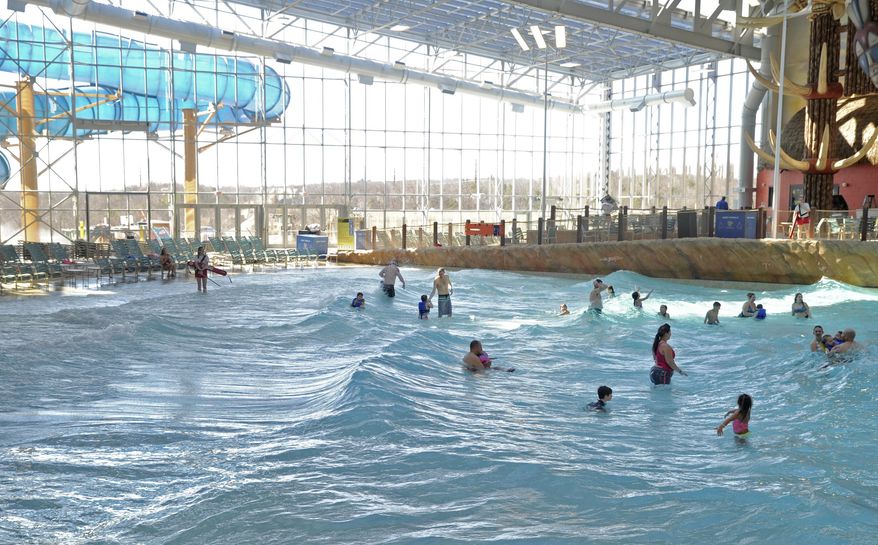 FILE - In this March 8, 2017, file photo, guests take a dip in a newly opened wave pool in the Kalahari Resort and Convention Center's indoor water park in Pocono Manor, Pa. The picturesque Pocono Mountains region is re-emerging as a haven for family fun, much as it was in the 1950s, with the popularity of indoor water park resorts that provide year-round entertainment. (Keith R. Stevenson/Pocono Record via AP, File)