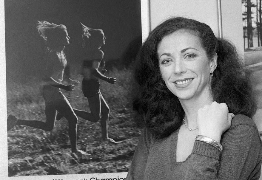 FILE - In this May 22, 1980 file photo, pioneer woman marathoner Kathrine Switzer stands in her New York office. In 1967, Switzer became the first woman to run with an official bib number in the Boston Marathon. A new film that captures much of the Boston Marathon's colorful history premieres Saturday, April 15, 2017, in conjunction with the 121st running of the race on Monday. (AP Photo/Suzanne Vlamis, File)