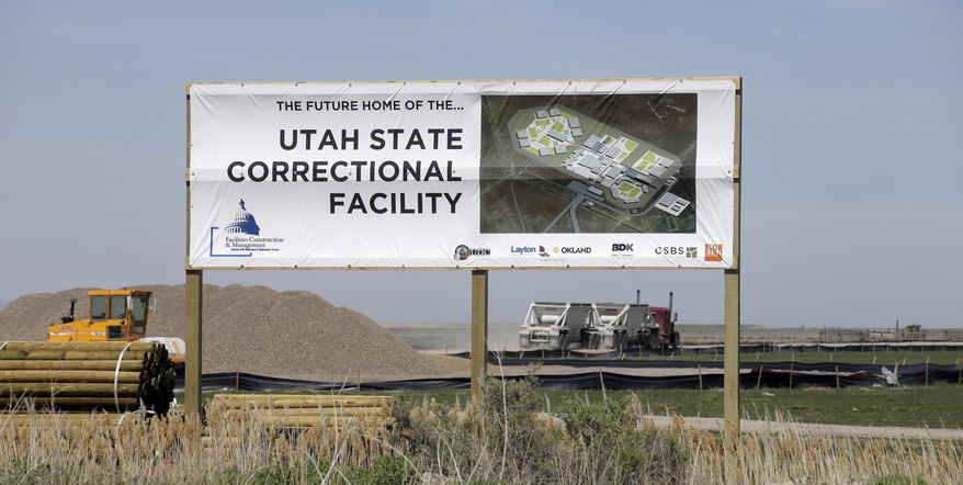 In this April 6, 2017, photo, a sign showing the future site of the Utah State Correction facility is displayed near the Salt Lake City International Airport. State officials say the new state prison is expected to be done by the end of 2020 as scheduled, but that inmates won't be moved there until the following year. Officials said Friday, April 14, 2017, during a Prison Development Commission hearing that it will take about six months to transition prisoners from the current facility in Draper to the new one about 25 miles north near the Salt Lake City International Airport. (AP Photo/Rick Bowmer)