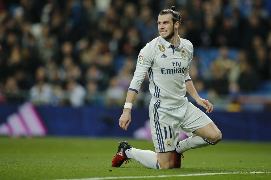 FILE - In this file photo dated Wednesday March 1, 2017, Real Madrid's Gareth Bale reacts during a Spanish La Liga soccer match between Real Madrid and Las Palmas at the Santiago Bernabeu stadium in Madrid, Spain. Real Madrid will have to continue its push toward its first Spanish league title in five years without the injured Gareth Bale, after Coach Zidane Zidane confirmed Friday April 14, 2017, a leg injury will stop Bale playing upcoming Saturday. (AP Photo/Paul White, FILE)