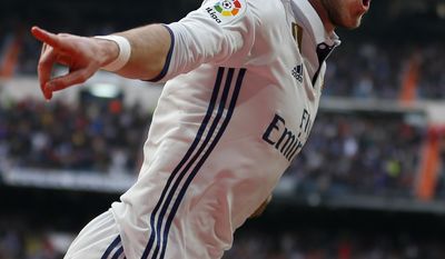 FILE - In this file photo dated Saturday, Feb. 18, 2017, Real Madrid&#x27;s Gareth Bale celebrates after scoring his side&#x27;s second goal against Espanyol during a Spanish La Liga soccer match between Real Madrid and Espanyol at the Santiago Bernabeu stadium in Madrid.  Real Madrid will have to continue its push toward its first Spanish league title in five years without the injured Gareth Bale, after Coach Zidane Zidane confirmed Friday April 14, 2017, a leg injury will stop Bale playing upcoming Saturday.(AP Photo/Francisco Seco, FILE)