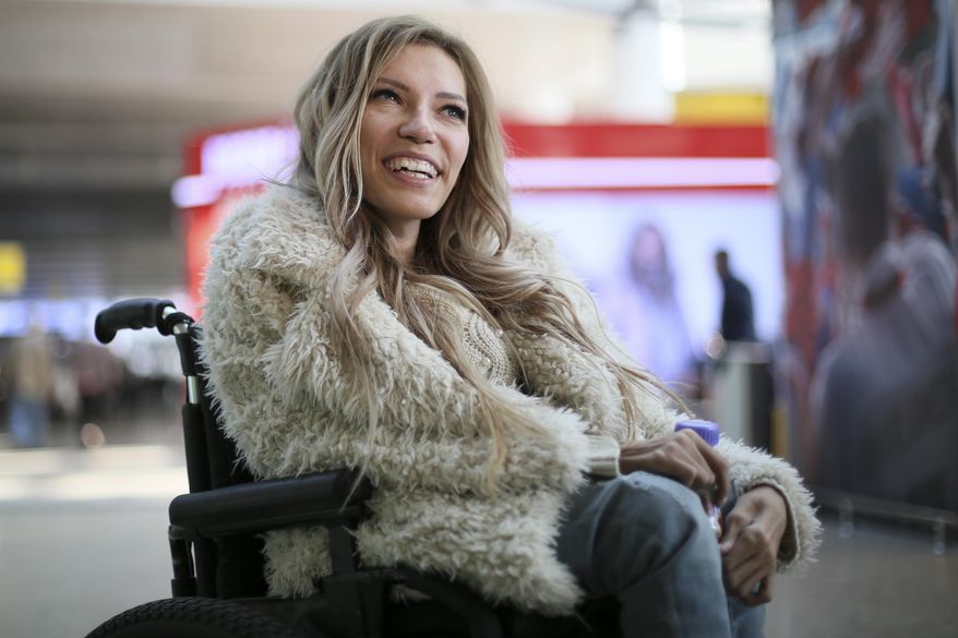 FILE - In this file photo dated Tuesday, March 14, 2017, Russian singer Yulia Samoylova who was chosen to represent Russia in the 2017 Eurovision Song Contest, poses while sitting in a wheelchair at Sheremetyevo airport outside Moscow, Russia. Russia's Channel One says it will not broadcast the Eurovision Song Contest in Russia after Ukraine, which hosts the contest this year, has barred the Russian entrant from traveling to the country. (AP Photo/Maria Antipina, FILE)