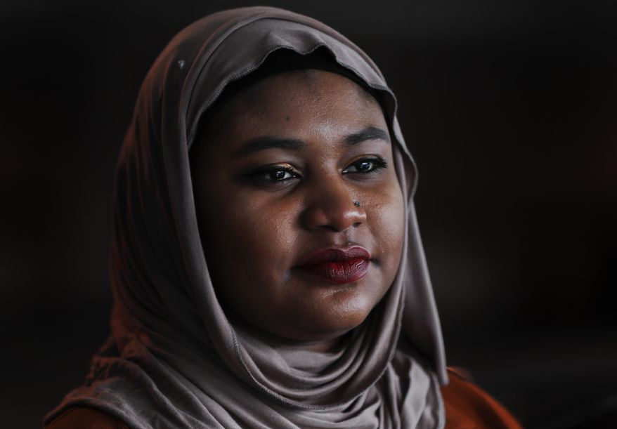 Fatimah Farooq is shown, Tuesday, March 14, 2017 in Ann Arbor, Mich. Farooq counsels refugees from places like Iraq and Syria, who have been victims of trauma, torture or sex trafficking. Personally, she tries to help relatives from Sudan, some of whom have faced barriers resettling in the United States as her parents did right before she was born. In between, she is trying to navigate being black, Muslim and a daughter of immigrants.(AP Photo/Paul Sancya)