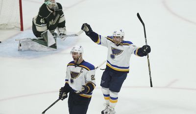 St. Louis Blues&#39; David Perron (57) and Alex Pietrangelo (27) celebrate after their team scored the winning goal against the Minnesota Wild during the third period of Game 2 of an NHL hockey first-round playoff series Friday, April 14, 2017, in St. Paul, Minn. (AP Photo/Stacy Bengs)