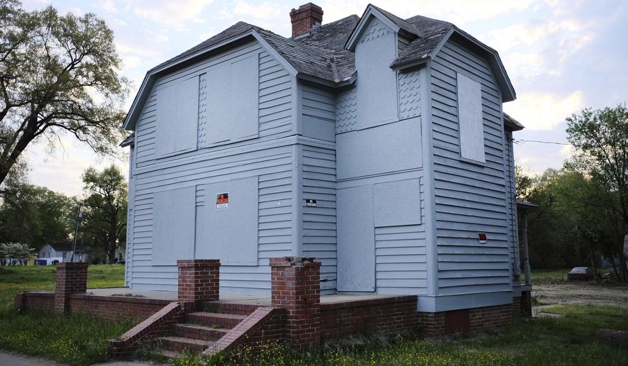 In this Thursday, April 13, 2017 photo, the owner of this house in south Richmond, Va., says he'll give it away- but there's a catch. The new owner will have to move it from the property. Built in about 1885 as a home for infirm and homeless Confederate veterans, the house has fallen into disrepair. (Ned Oliver/Richmond Times-Dispatch via AP)