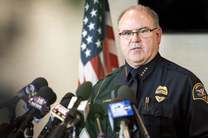 Janesville Police Chief Dave Moore speaks to reporters about the capture of Joseph Jakubowski on Friday, April 14, 2017, at the Southern Wisconsin Regional Airport in Janesville, Wis. The fugitive, accused of stealing an arsenal of firearms and sending an anti-government manifesto to the White House, was arrested Friday after a retired school counselor found Jakubowski camping on his property and calmly talked to him before calling authorities. (Angela Major/The Janesville Gazette via AP)