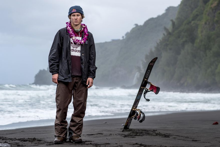 In this Feb. 21, 2017, photo provided by Red Bull, Lyon Farrell poses on a beach in Waipo Valley on the island of Hawaii. Farrell grew up skateboarding and surfing in Hawaii before a visit to New Zealand introduced him to snowboarding. Ever since, he's preferred landing triple corks to hanging 10 as he sets his sights on making the U.S. slopestyle squad for the Olympics next winter in South Korea. (Zak Noyle/Red Bull via AP)