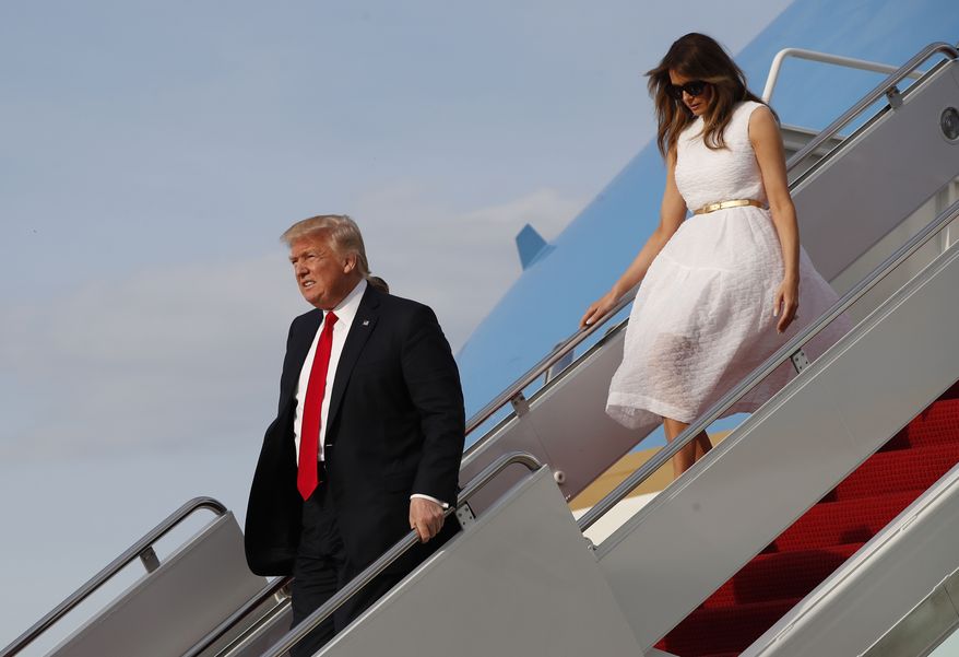 President Donald Trump with first lady Melania Trump walk down the steps of Air Force One as they arrive Sunday, April 16, 2017, at Andrews Air Force Base, Md. Trump is returning from his Mar-a-Largo resort in Florida. (AP Photo/Alex Brandon)