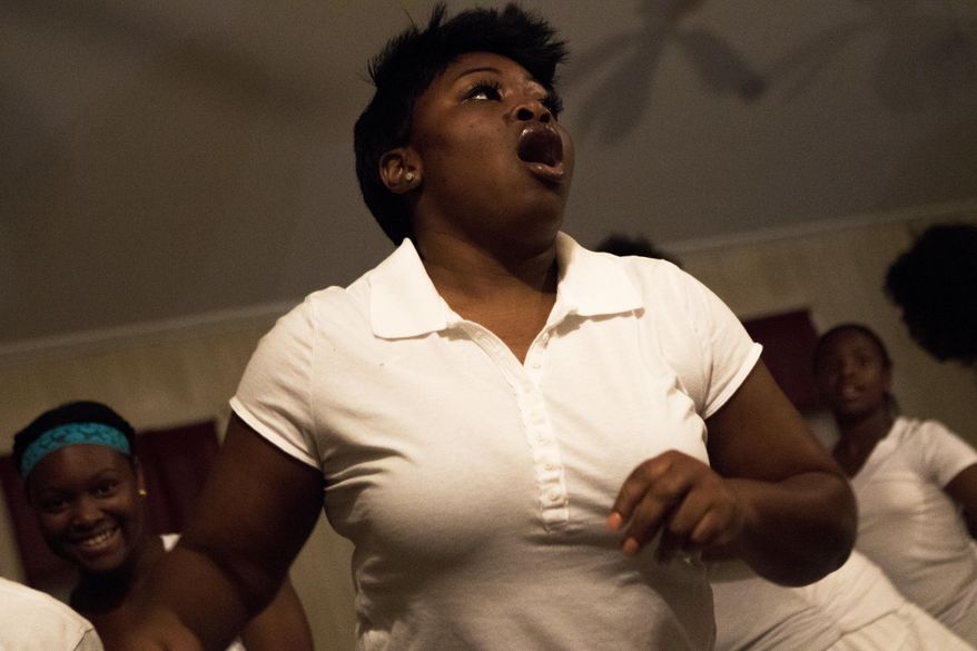 In this Saturday, April 15, 2017, photo, Nikiya Pleasant sings as she participates in the procession during the Easter Rock at Original True Light Baptist Church in Winnsboro, La. The public was invited to attend the annual Easter vigil ceremony, Rocking to a Risen Savior, at the old plantation church Saturday. (Hannah Baldwin/The News-Star via AP)
