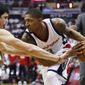 Washington Wizards guard Bradley Beal, right, is guarded by Atlanta Hawks forward Ersan Ilyasova, left,  during the first half in Game 1 of a first-round NBA basketball playoff series, in Washington, Sunday, April 16, 2017. (AP Photo/Manuel Balce Ceneta)