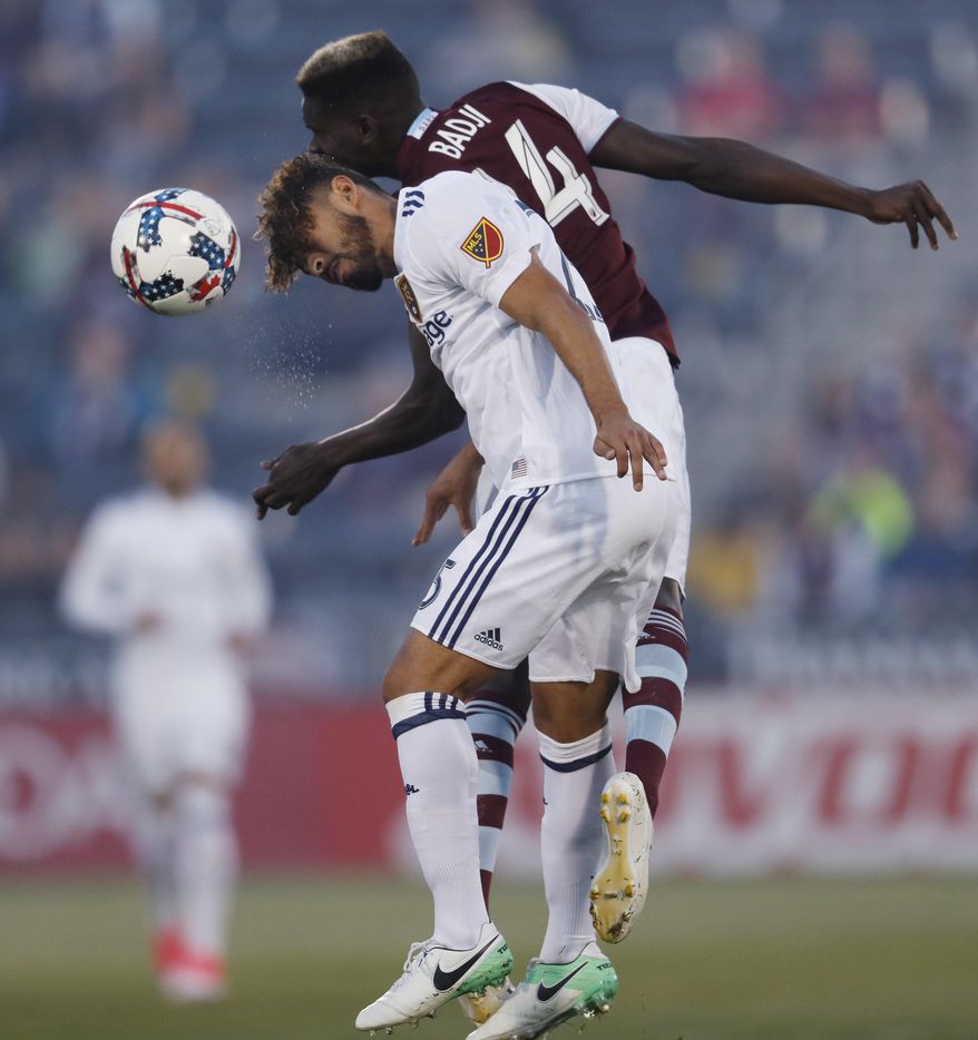 Real Salt Lake midfielder Danilo Acosta, front, takes to the air with Colorado Rapids forward Dominique Badji to head the ball in the first half of an MLS soccer match, Saturday, April 15, 2017, in Commerce City, Colo. (AP Photo/David Zalubowski)
