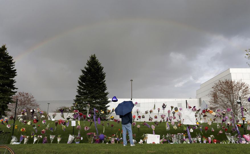 FILE - In this April 21, 2016, file photo, a rainbow appears over Prince's Paisley Park estate near a memorial for the rock superstar in Chanhassen, Minn. Nearly a year after Prince died from an accidental drug overdose in his suburban Minneapolis studio and estate, investigators still haven't interviewed a key associate nor asked a grand jury to investigate potential criminal charges, according to an official with knowledge of the investigation. (Carlos Gonzalez/Star Tribune via AP, File)
