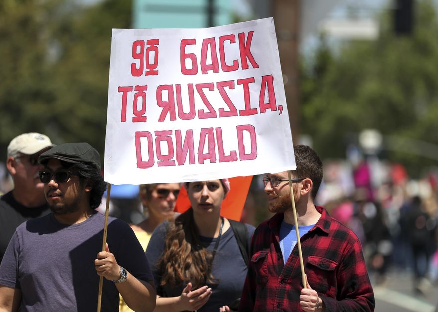 Demonstrators protest President Donald Trump's failure to release his tax returns and a host of other issues during a march and rally in downtown Los Angeles Saturday, April 15, 2017. (AP Photo/Reed Saxon)