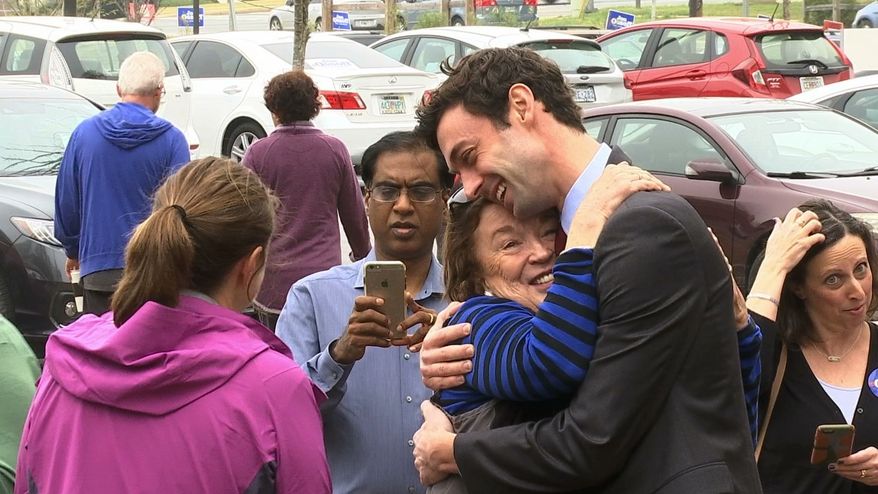 In a Monday, March 27, 2017, file photo, Democratic Congressional candidate Jon Ossoff greets supporters outside of the East Roswell Branch Library in Roswell, Ga., on the first day of early voting. President Donald Trump is attacking the leading Democratic candidate for a special election in a typically conservative Georgia congressional district, with Republicans bidding to avoid a major upset. On Twitter, Trump said Monday April 17, 2017, that "The super Liberal Democrat in the Georgia Congressional race tomorrow wants to protect criminals, allow illegal immigration and raise taxes!" (AP Photo/Alex Sanz)