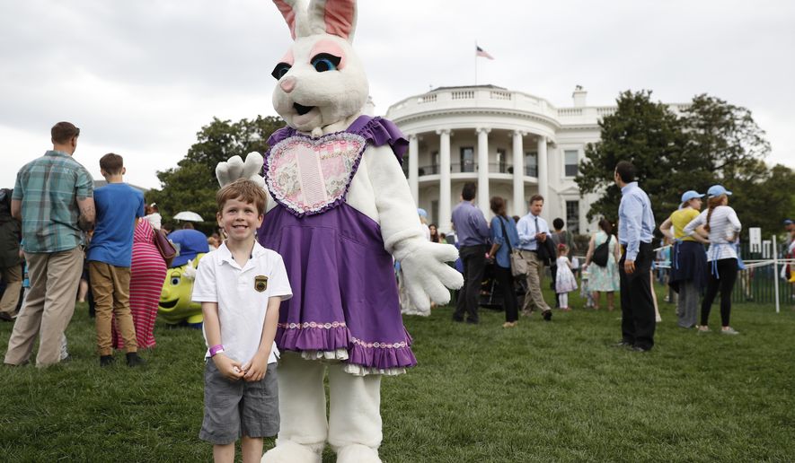 Michael McGee, 5, poses with an Easter bunny during the White House Easter Egg Roll on the South Lawn of the White House in Washington, Monday, April,17, 2017. President Donald Trump and first lady Melania Trump are set to host the official annual Easter egg roll at the White House.(AP Photo/Carolyn Kaster)