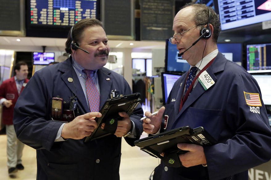 Traders John Santiago, left, and Gordon Charlop confer on the floor of the New York Stock Exchange, Monday, April 17, 2017. Technology and consumer-focused stocks are leading indexes slightly higher in early trading as investors return from a long holiday weekend. (AP Photo/Richard Drew)