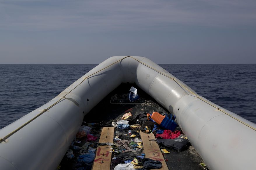 In this April 6, 2017, view of an empty rubber boat after migrants were rescued by members of Proactive Open Arms NGO, in the Mediterranean sea, about 56 miles north of Sabratha, Libya. (AP Photo/Bernat Armangue)