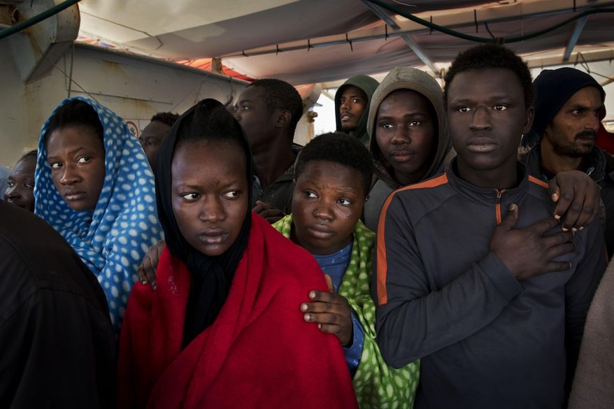 FILE - In this April 8, 2017 file photo, migrants aboard the Golfo Azurro rescue vessel wait to be transferred to Italian authorities in Trapani harbor, in the Italian island of Sicily. Most, though, don't understand that this could be just one more step in an impossible dream. Many are sent to government-run migrant camps. Others, depending on international agreements, are sent back home. (AP Photo/Bernat Armangue, File)