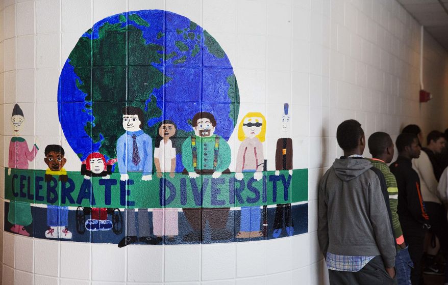 ADVANCE FOR USE WEDNESDAY, APRIL 19, 2017 AND THEREAFTER-A mural celebrating diversity decorates a hallway in Lewiston High School in Lewiston, Maine, Wednesday, March 15, 2017. Fifteen years ago, the school district had an enrollment of 4,500 students and falling _ a sign of a city on its knees, says Lewiston School Superintendent Bill Webster. Today, there are 5,400 students, more than one-quarter of them immigrants, and the number is going up. (AP Photo/David Goldman)
