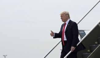 President Donald Trump gives a thumbs-up as he walks down the steps of Air Force One at General Mitchell International Airport in Milwaukee, Tuesday, April 18, 2017. Trump is heading to Kenosha, Wis., to visit the headquarters of tool manufacturer Snap-on Inc., and sign an executive order that seeks to make changes to a visa program that brings in high-skilled workers. (AP Photo/Susan Walsh)