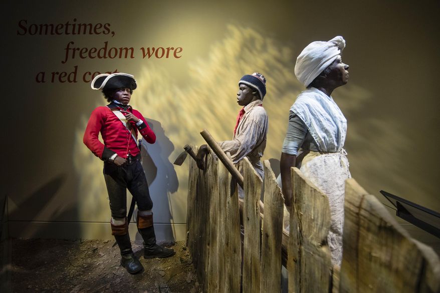 This Thursday, April 13, 2017 photo depicts a fourteen-year-old London Pleasants, left, who left slavery by joining a Loyalist regiment encouraging other slaves to flee to the British Army in search freedom, at the Museum of the American Revolution in Philadelphia. (AP Photo/Matt Rourke)