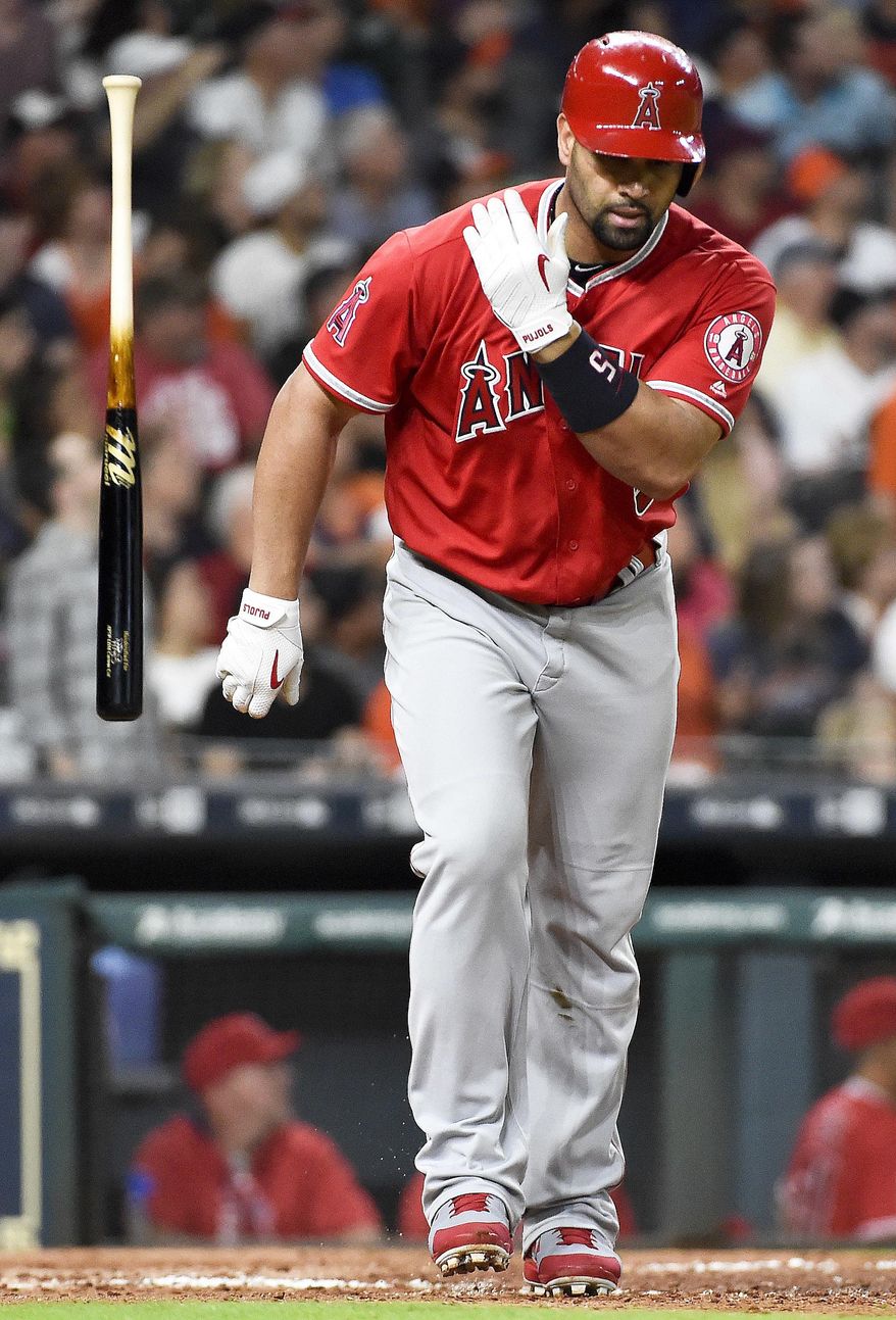 Los Angeles Angels' Albert Pujols throws his bat after hitting a three-run home run off Houston Astros starting pitcher Joe Musgrove in the fifth inning of a baseball game, Tuesday, April 18, 2017, in Houston. (AP Photo/Eric Christian Smith)