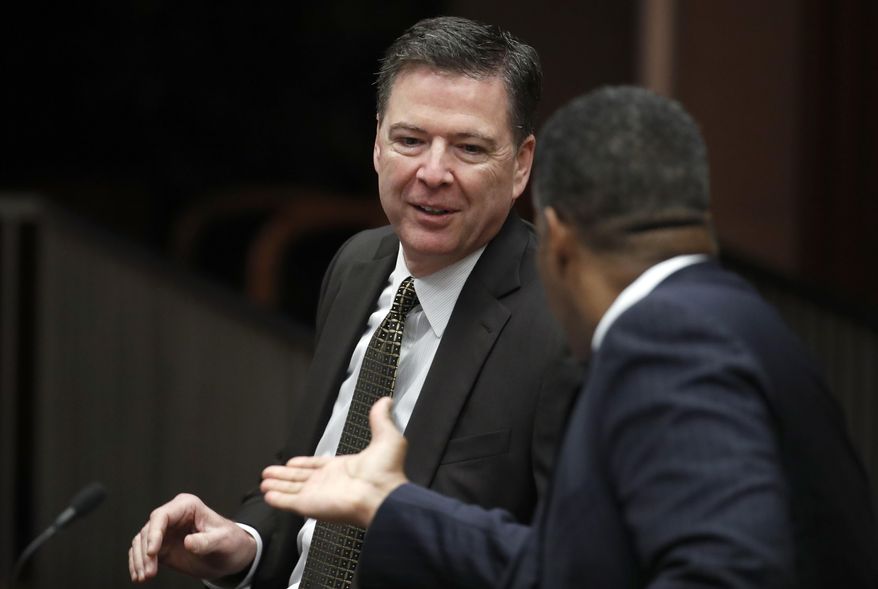 FBI Director James Comey, left, is greeted by Peter T. Edge, the Executive Associate Director for Homeland Security Investigations at US Immigration and Customs Enforcement, before a meeting of the Attorney General's Organized Crime Council and Organized Crime Drug Enforcement Task Forces (OCDETF) Executive Committee to discuss implementation of the President's Executive Order 13773, Tuesday, April 18, 2017, at the Justice Department in Washington. (AP Photo/Alex Brandon)