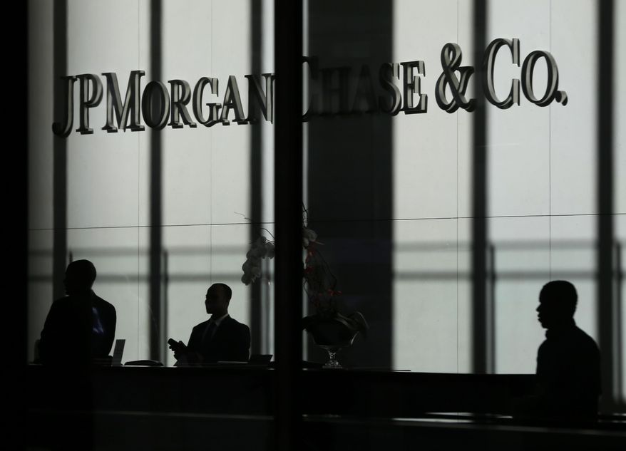 In this Monday, Oct. 21, 2013, file photo, the JPMorgan Chase &amp;amp; Co. logo is displayed at their headquarters in New York. Banking executives and consultants who normally focus on checking accounts and credit cards spent a recent conference talking about “cross-selling” and “incentive compensation.” Those are code words for Wells Fargo, and the up to 2 million accounts that its employees opened without customer permission as they sought to meet unrealistic sales goals. JPMorgan Chase officials say they&#x27;ve looked at their bank&#x27;s sales behavior and have found nothing amiss. (AP Photo/Seth Wenig, File)