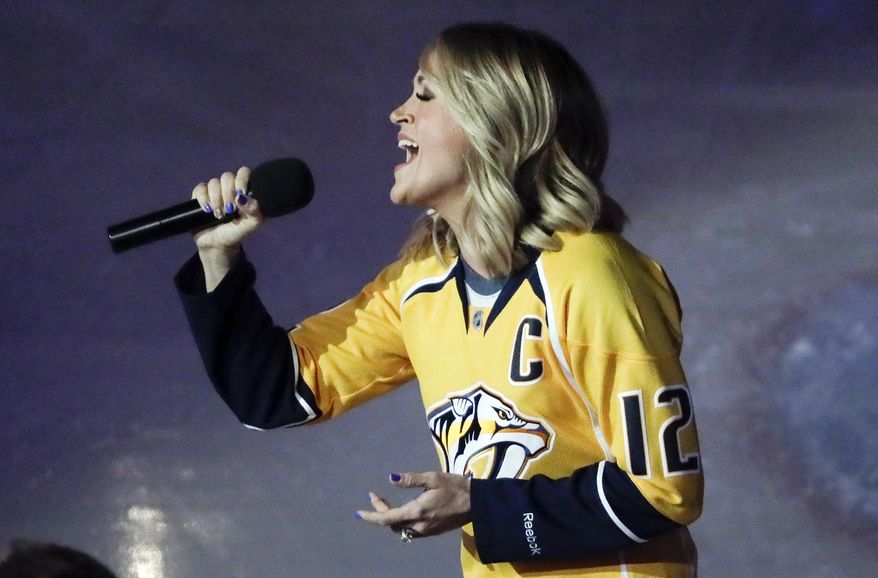 Country music star Carrie Underwood performs the national anthem before Game 3 of a first-round NHL hockey playoff series between the Predators and the Chicago Blackhawks Monday, April 17, 2017, in Nashville, Tenn. Underwood is the wife of Predators center Mike Fisher. (AP Photo/Mark Humphrey)