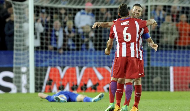 Atletico Madrid&#x27;s Gabi, right, and Koke, 6, celebrate after the Champions League quarterfinal second leg soccer match between Leicester City and Atletico Madrid at King Power Stadium, Leicester, England, Tuesday, April 18, 2017. (AP Photo/Rui Vieira)