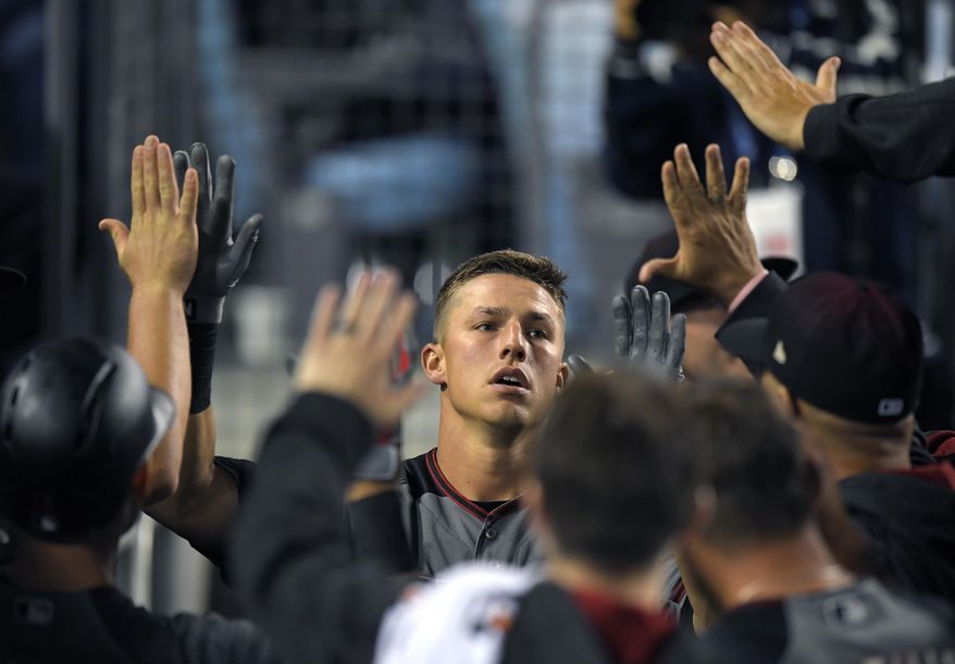 Arizona Diamondbacks' Jake Lamb is congratulated by teammates after hitting a solo home run during the eighth inning of a baseball game against the Los Angeles Dodgers, Monday, April 17, 2017, in Los Angeles. (AP Photo/Mark J. Terrill)