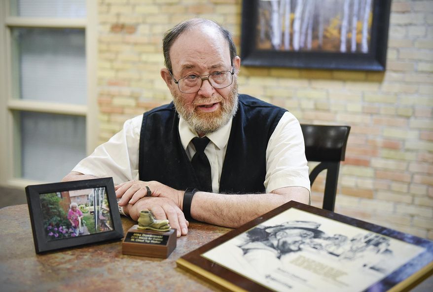 ADVANCE FOR WEEKEND USE SATURDAY, APRIL 22 AND THEREAFTER - In this Thursday, April 13, 2017 photo, Mike Dombrovski talks about raising money for the March of Dimes for more than 40 years at his apartment in St. Cloud, Minn. That commitment to March of Dimes has earned Dombrovski some of the highest honors in the national organization. (Jason Wachter/St. Cloud Times via AP)