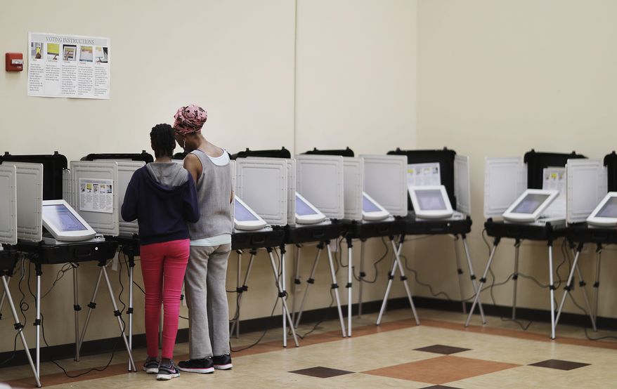 A voter casts a ballot in a special election in Atlanta, Tuesday, April 18, 2017. Republicans are bidding to prevent a major upset in a conservative Georgia congressional district Tuesday where Democrats stoked by opposition to President Donald Trump have rallied behind a candidate who has raised a shocking amount of money for a special election. (AP Photo/David Goldman)