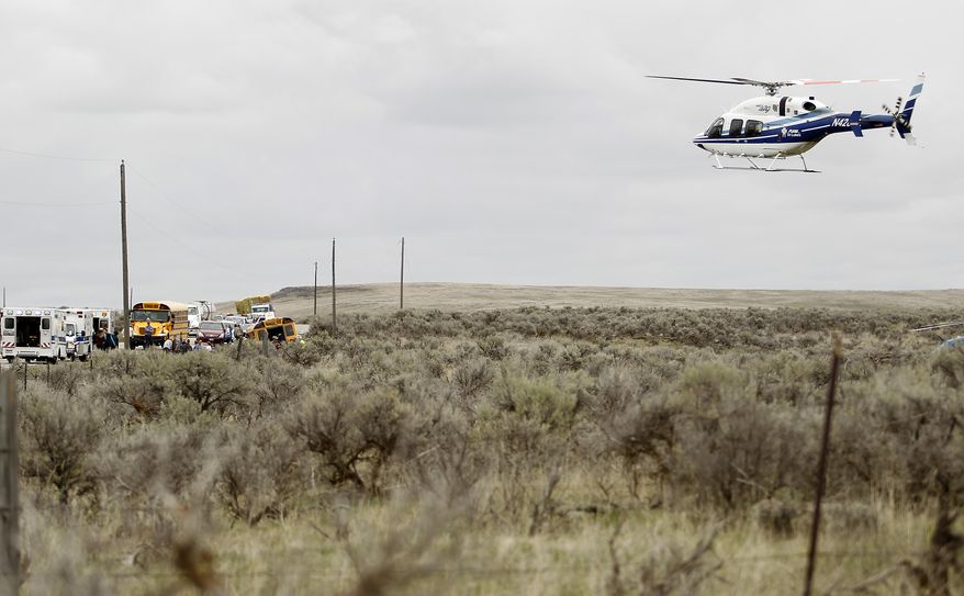 A medical helicopter takes off from the scene of a bus crash Tuesday, April 18, 2017, west of Richfield, Idaho. At least 17 students have been taken to hospitals, some with serious injuries, after a bus carrying 39 students to a track meet rolled over on a rural stretch of road in central Idaho. (Drew Nash/The Times-News via AP)