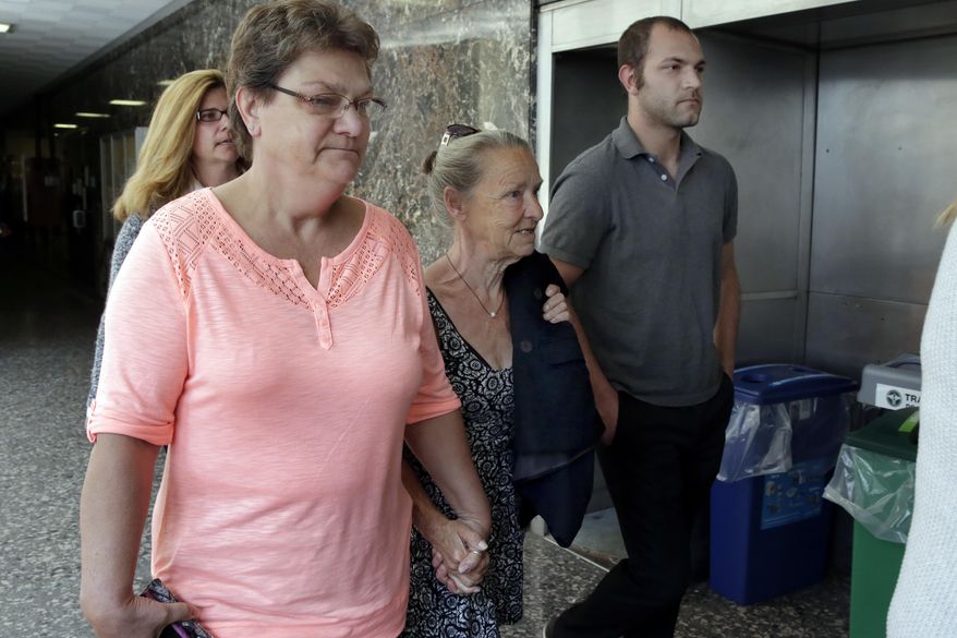Julie Patz, center, mother of Etan Patz, leaves Manhattan Supreme Court, in New York, Tuesday, April 18, 2017, after the sentencing of Pedro Hernandez, the man convicted of killing 6-year-old Etan Patz, one of America's most notorious missing-child cases. (AP Photo/Richard Drew)