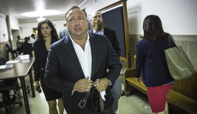 In this Monday, April 17, 2017 photo, &amp;quot;Infowars&amp;quot; host Alex Jones arrives at the Travis County Courthouse in Austin, Texas. Jones, the right-wing radio host and conspiracy theorist, is a performance artist whose true personality is nothing like his on-air persona, according to a lawyer defending the &amp;quot;Infowars&amp;quot; broadcaster in a child custody battle. (Tamir Kalifa/Austin American-Statesman via AP)