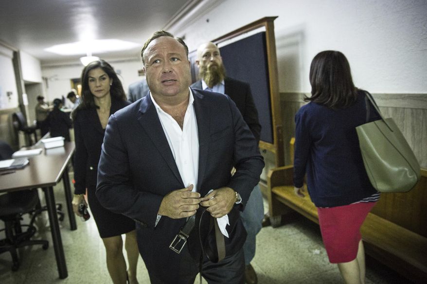 In this Monday, April 17, 2017 photo, &amp;quot;Infowars&amp;quot; host Alex Jones arrives at the Travis County Courthouse in Austin, Texas. Jones, the right-wing radio host and conspiracy theorist, is a performance artist whose true personality is nothing like his on-air persona, according to a lawyer defending the &amp;quot;Infowars&amp;quot; broadcaster in a child custody battle. (Tamir Kalifa/Austin American-Statesman via AP)
