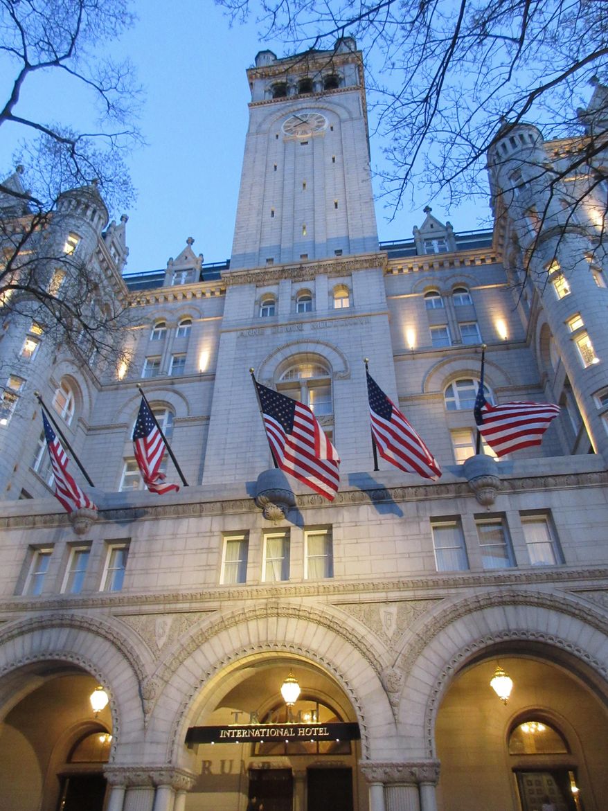 This April 13, 2017 image shows the clock tower above a sign for the Trump International Hotel, which is located inside the Old Post Office, a historic building in Washington D.C. The clock tower is operated by the National Park Service and was recently reopened to the public for tours. (AP Photos/Beth J. Harpaz)