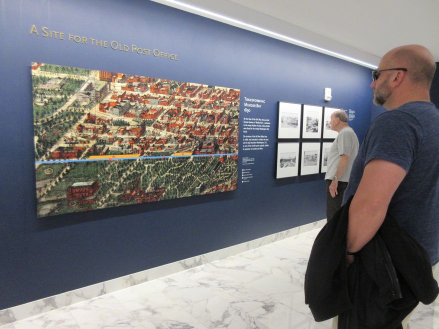 This April 13, 2017 image shows displays about the history of the neighborhood around the Old Post Office, a historic building in Washington D.C., where the Trump International Hotel is located. The exhibit hallway leads to an elevator that takes visitors to a clock tower operated by the National Park Service. The clock tower recently reopened to the public for tours. (AP Photos/Beth J. Harpaz)