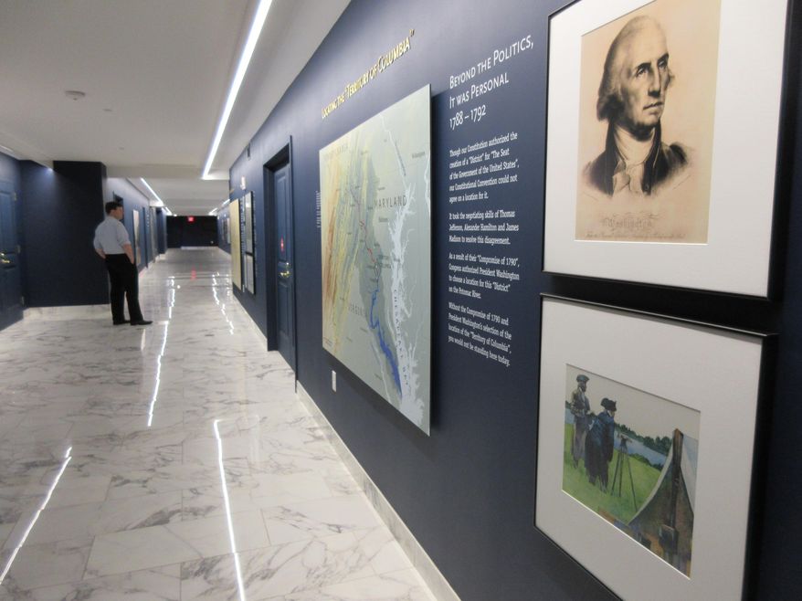 This April 13, 2017 image shows displays about the history of the neighborhood around the Old Post Office, a historic building in Washington D.C., where the Trump International Hotel is located. The exhibit hallway leads to an elevator that takes visitors to a clock tower operated by the National Park Service. The clock tower recently reopened to the public for tours. (AP Photos/Beth J. Harpaz)