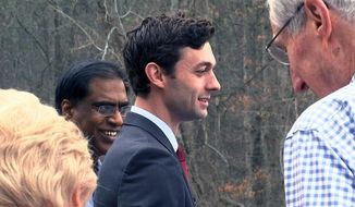 Democratic congressional candidate Jon Ossoff is seen with supporters outside of the East Roswell Branch Library in Roswell, Ga., on the first day of early voting, in this Monday, March 27, 2017, file photo. (AP Photo/Alex Sanz)