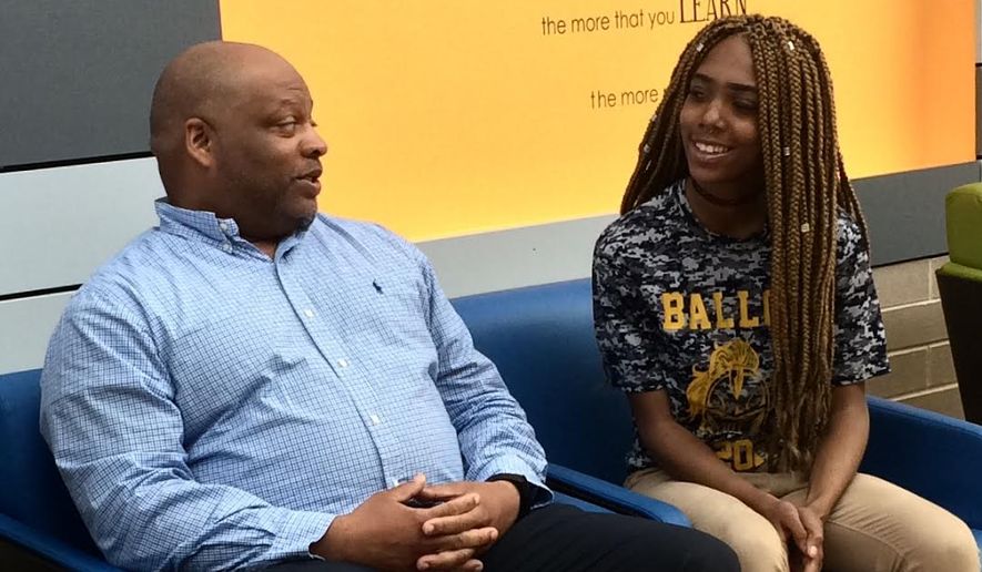 Nelson Greene, Pathways coordinator at Ballou High School, is helping all-star athlete Mikayla Hooks find a clear academic direction so she can continue her cheerleading career. (Julia Brouillette/The Washington Times)