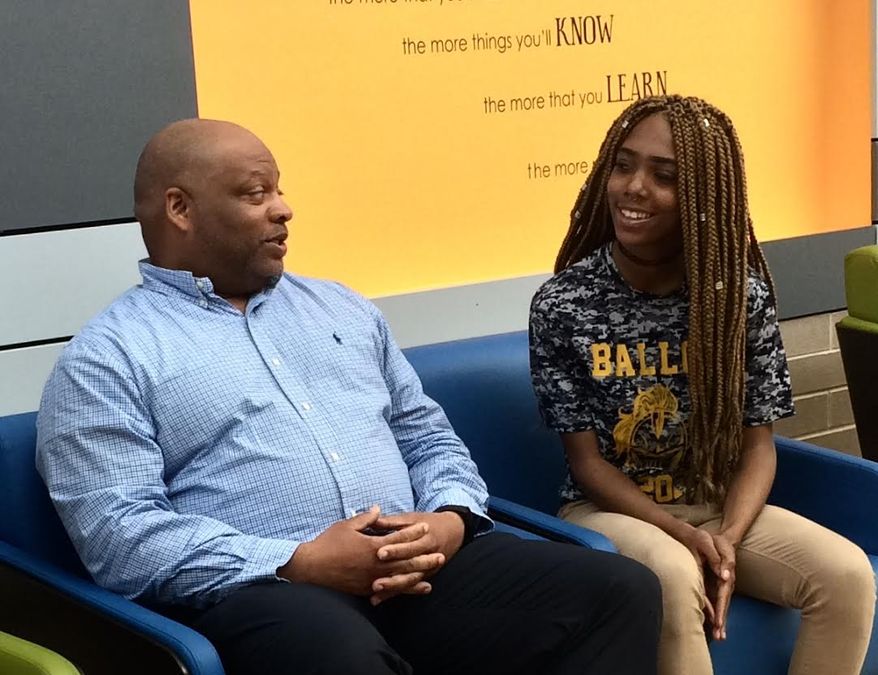 Nelson Greene, Pathways coordinator at Ballou High School, is helping all-star athlete Mikayla Hooks find a clear academic direction so she can continue her cheerleading career. (Julia Brouillette/The Washington Times)