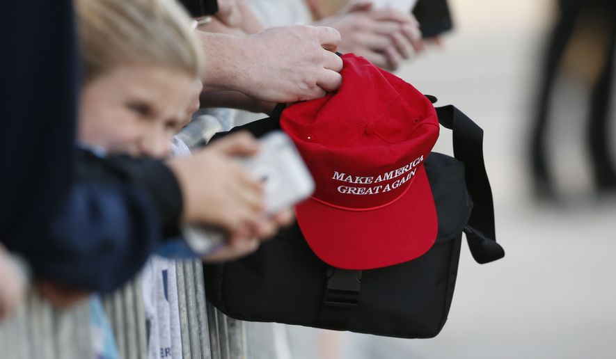 A supporter holding a &quot;Make America Great Again,&quot; hat waits to greet President Donald Trump when he arrives on Air Force One in West Palm Beach, Fla., Friday, Feb. 10, 2017. (AP Photo/Wilfredo Lee)